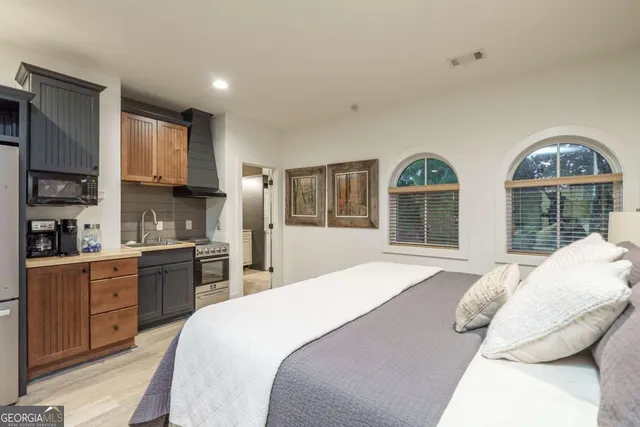 a spacious bedroom with a large bed and a large window