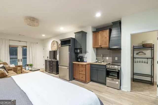 a kitchen with stainless steel appliances granite countertop a refrigerator stove and sink