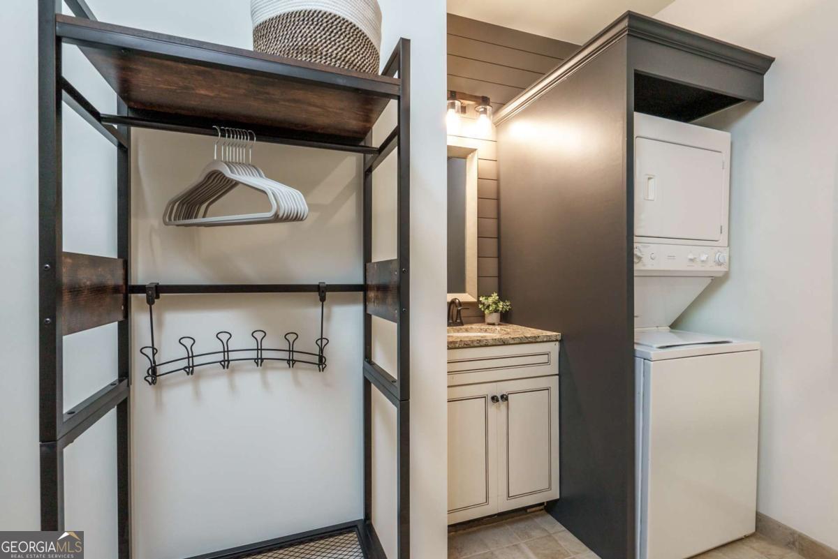 401 Cuscowilla Drive, Unit D Eatonton, GA 31024 - Photo 14 of 20 a utility room with cabinets and washer
