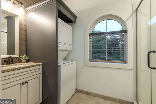 a view of bathroom with a toilet sink and mirror