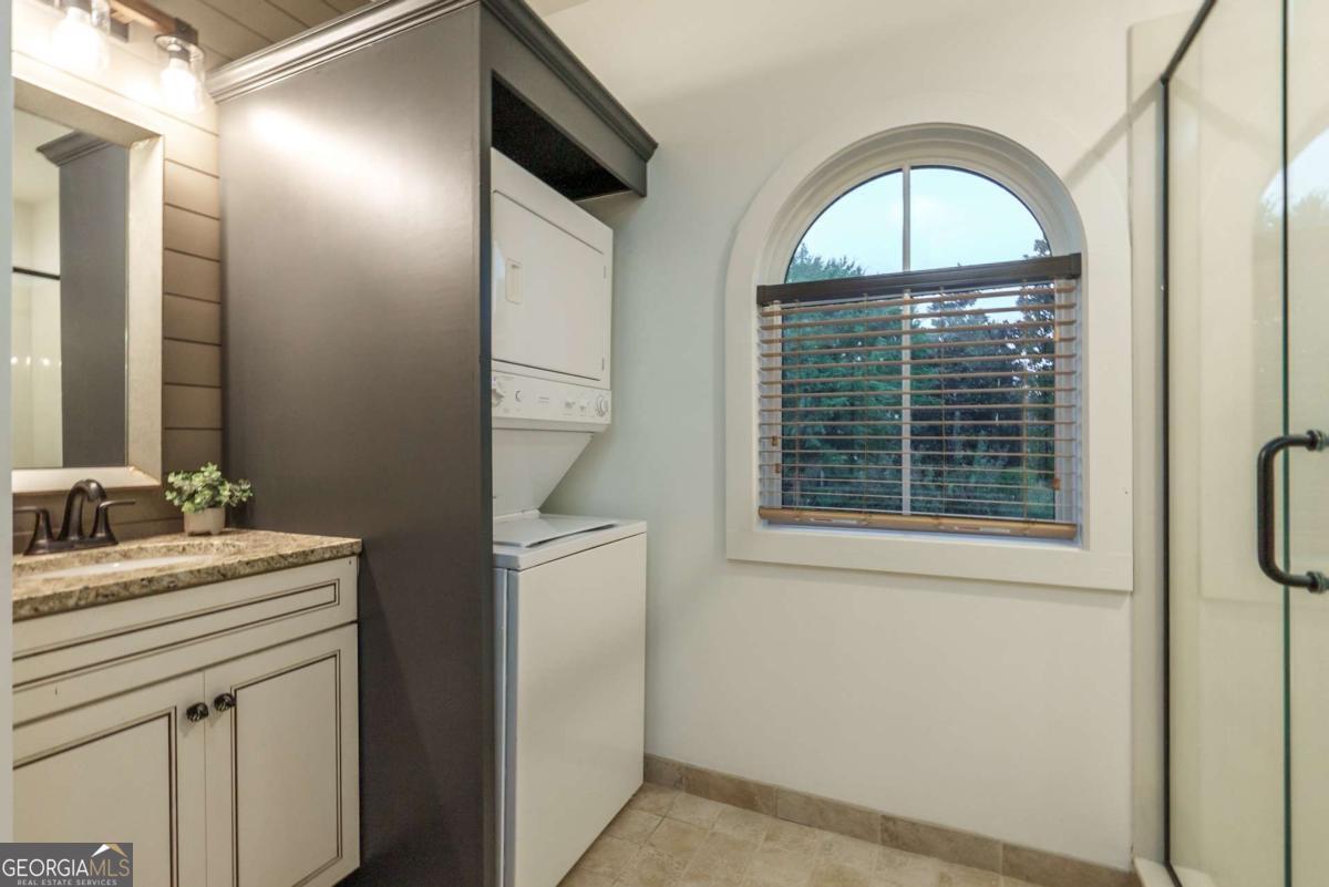 401 Cuscowilla Drive, Unit D Eatonton, GA 31024 - Photo 15 of 20 a view of bathroom with a toilet sink and mirror