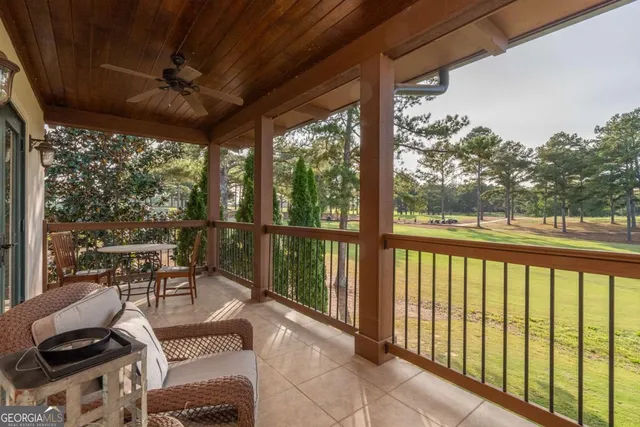 a balcony with chairs and wooden floor
