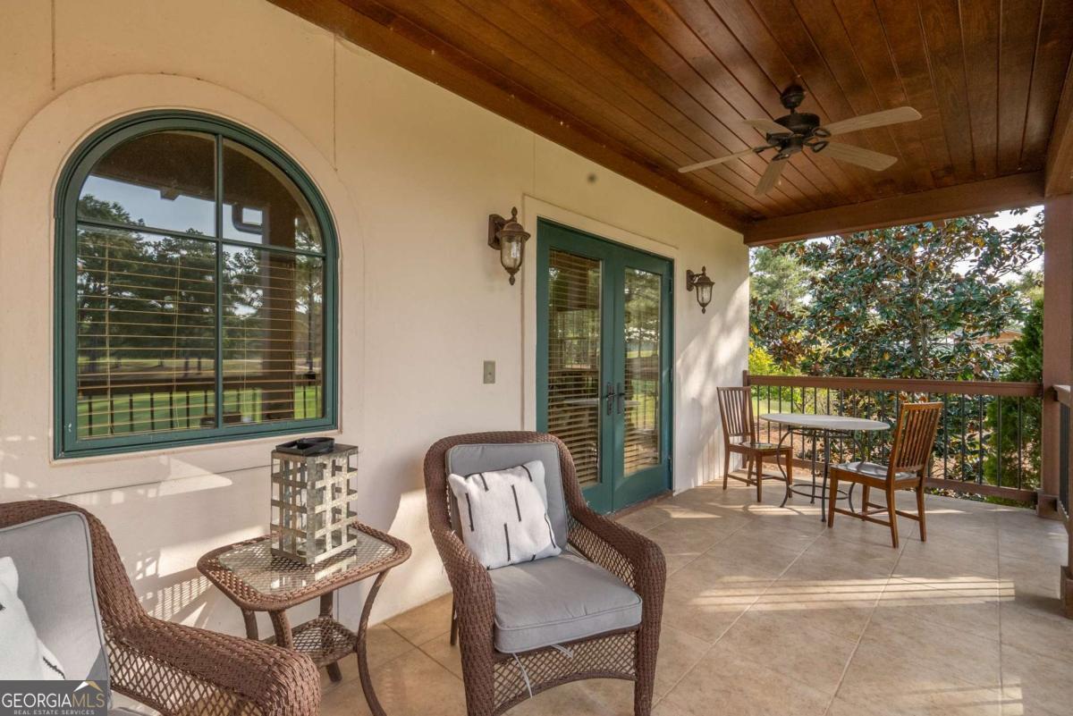 401 Cuscowilla Drive, Unit D Eatonton, GA 31024 - Photo 19 of 20 a view of a patio with table and chairs