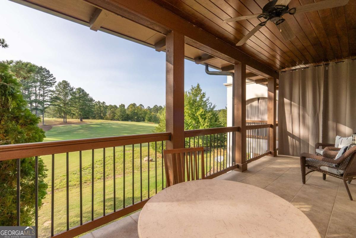 401 Cuscowilla Drive, Unit D Eatonton, GA 31024 - Photo 20 of 20 a balcony with chairs