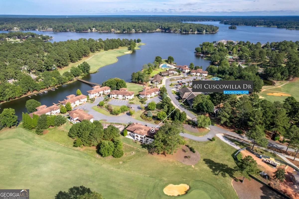 401 Cuscowilla Drive, Unit D Eatonton, GA 31024 - Photo 3 of 20 an aerial view of lake residential house with swimming pool and green space