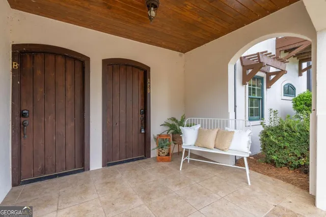 a white bench sitting in front of a door