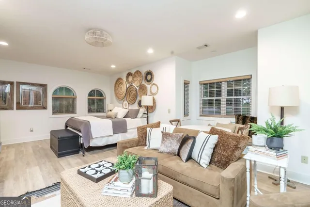 a living room with furniture or couch and a potted plant