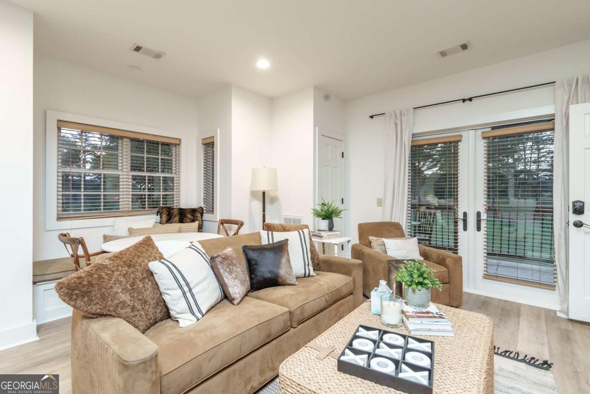 401 Cuscowilla Drive, Unit D Eatonton, GA 31024 - Photo 9 of 20 a living room with furniture and a large window