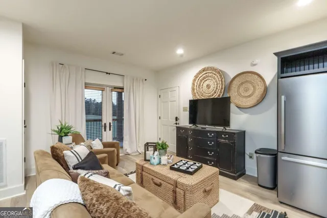a living room with furniture a large window and a fireplace