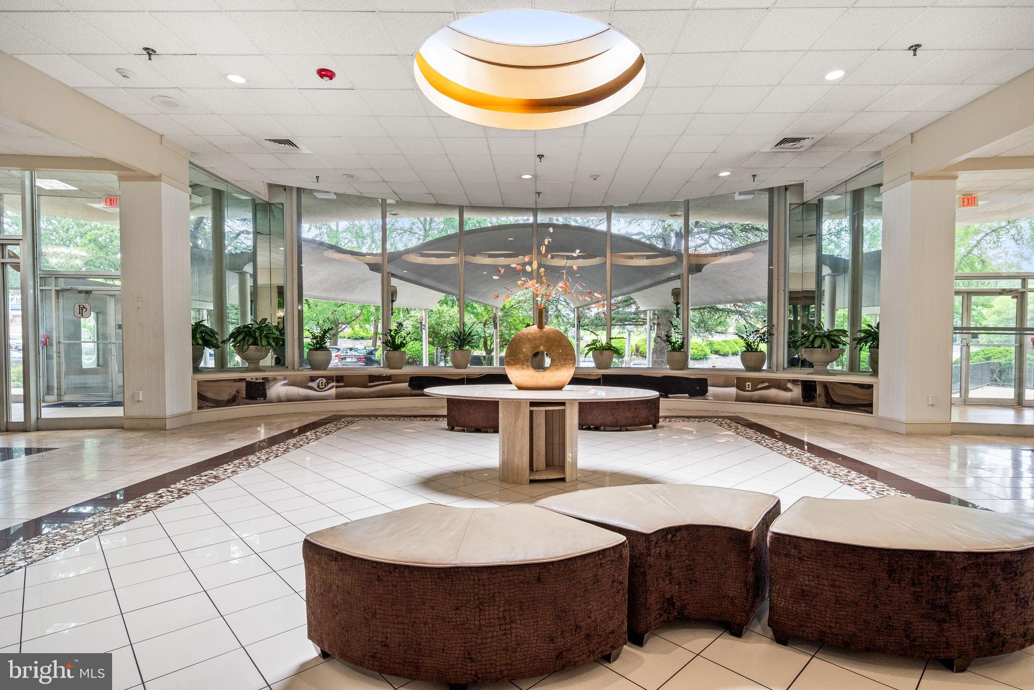 3900 West Ford Road, Unit 11B Philadelphia, PA 19131 - Photo 3 of 24 a room with lots of table chair windows and potted plants