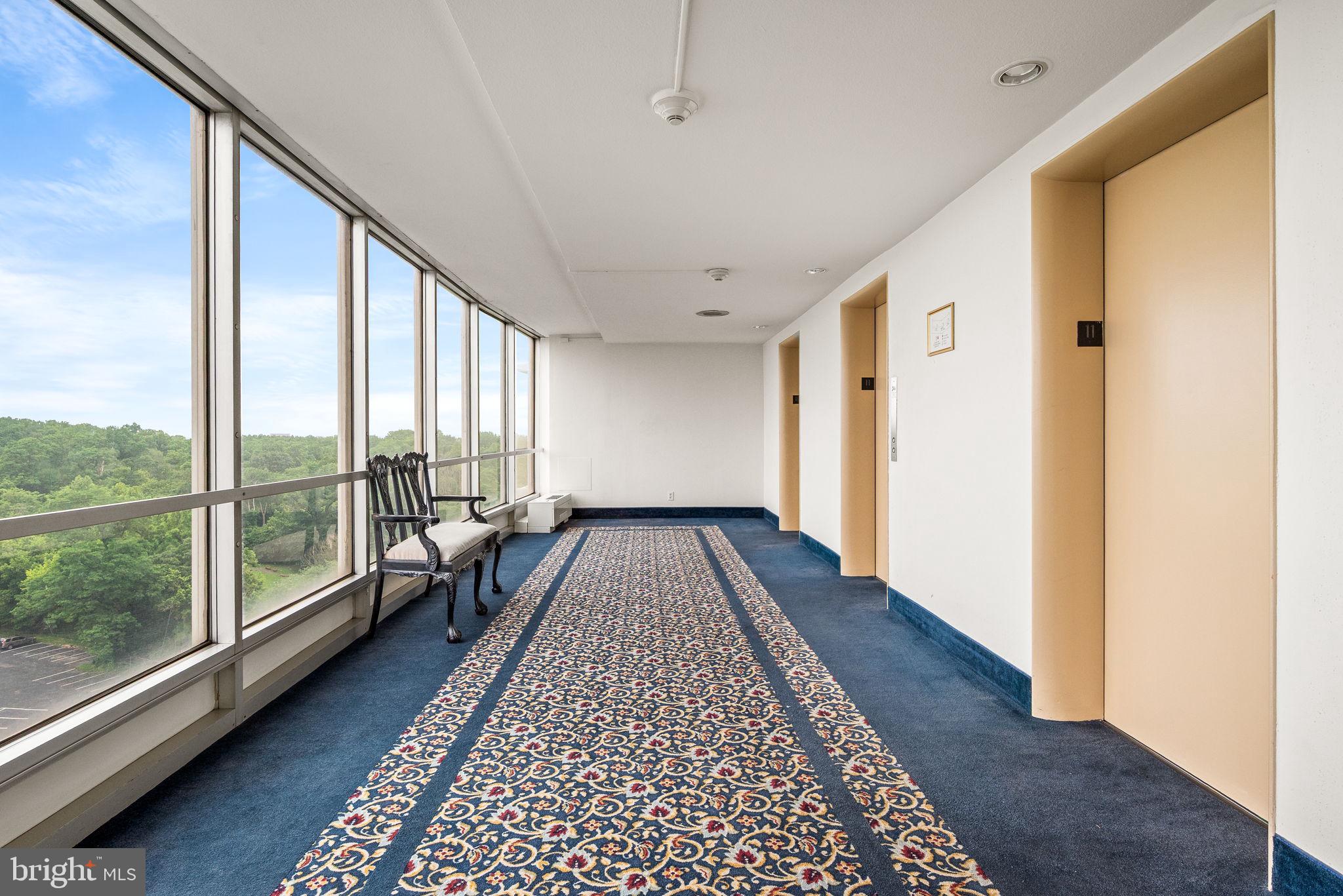 3900 West Ford Road, Unit 11B Philadelphia, PA 19131 - Photo 4 of 24 a view of a large room with wooden floor and windows