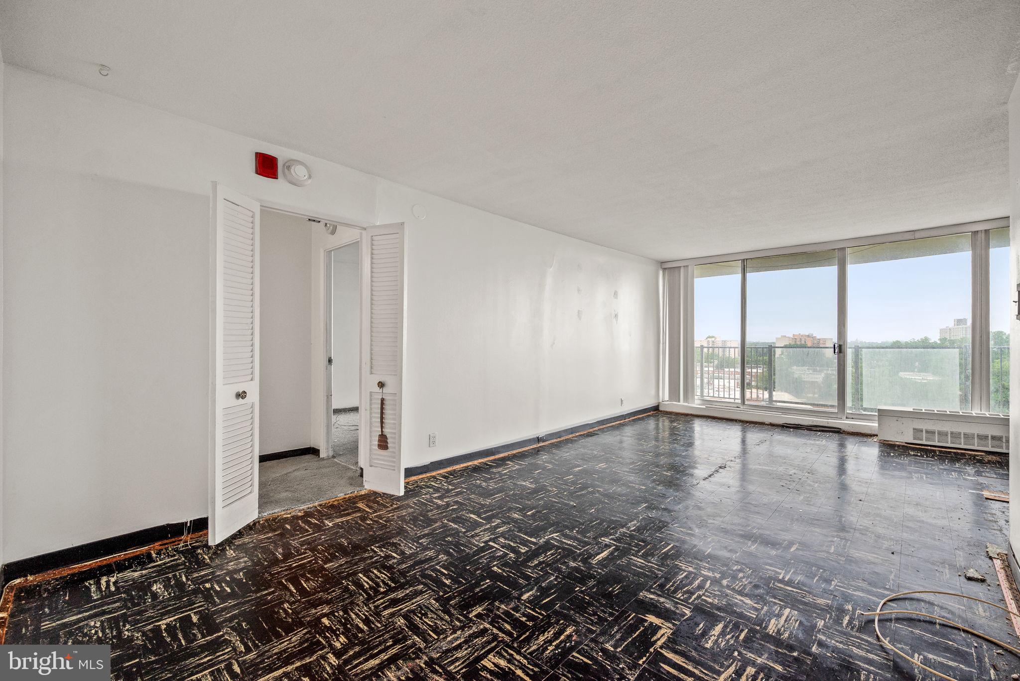 3900 West Ford Road, Unit 11B Philadelphia, PA 19131 - Photo 6 of 24 wooden floor in an empty room with a window