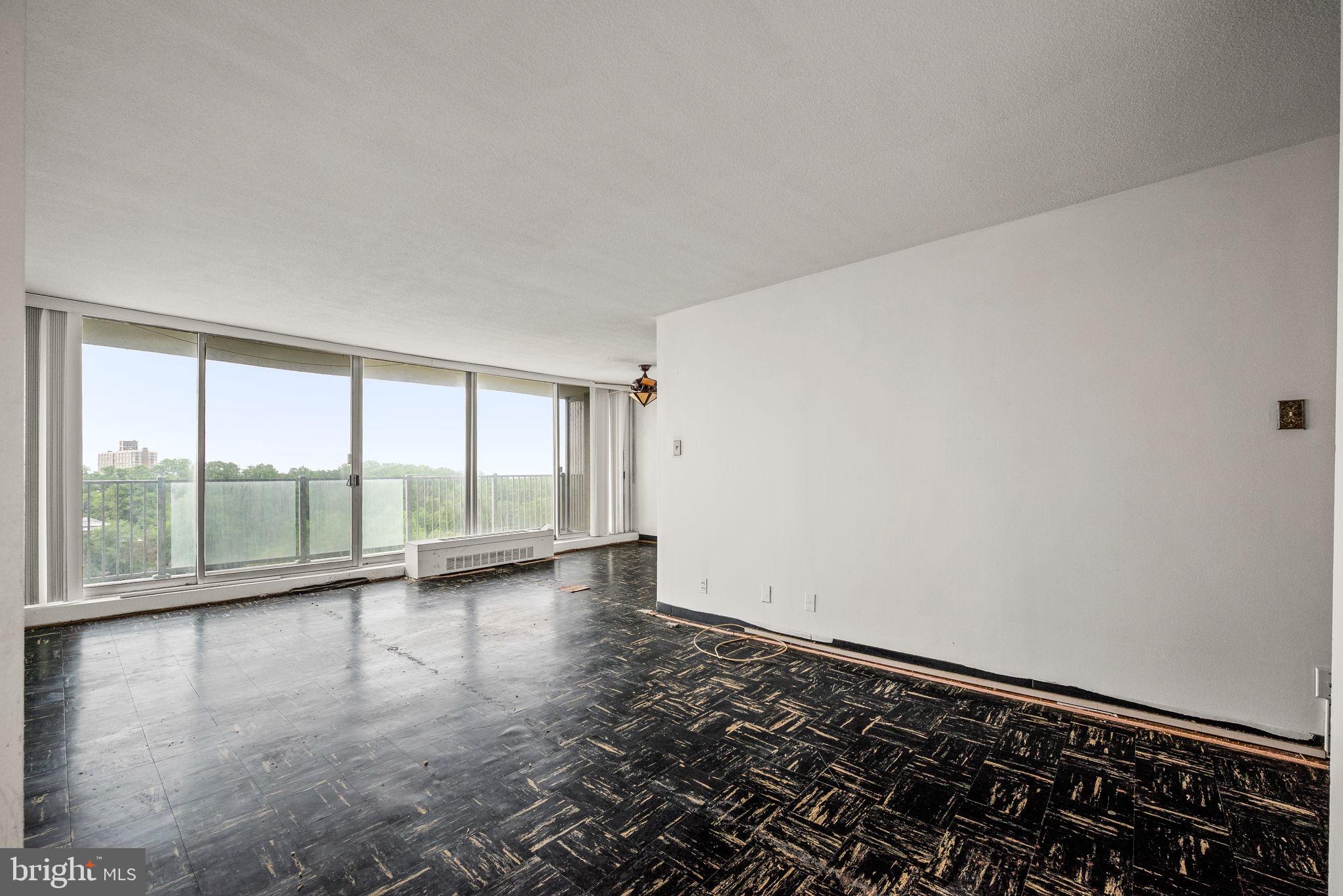 3900 West Ford Road, Unit 11B Philadelphia, PA 19131 - Photo 7 of 24 wooden floor in an empty room with a window