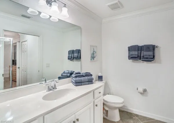 a bedroom with two beds and a chandelier