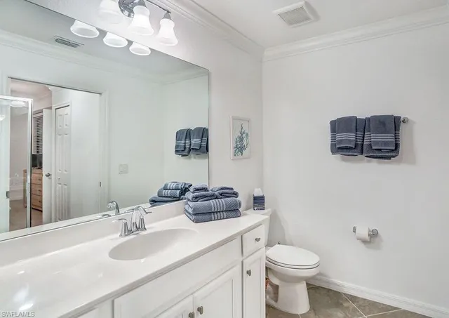 a bedroom with two beds and a chandelier