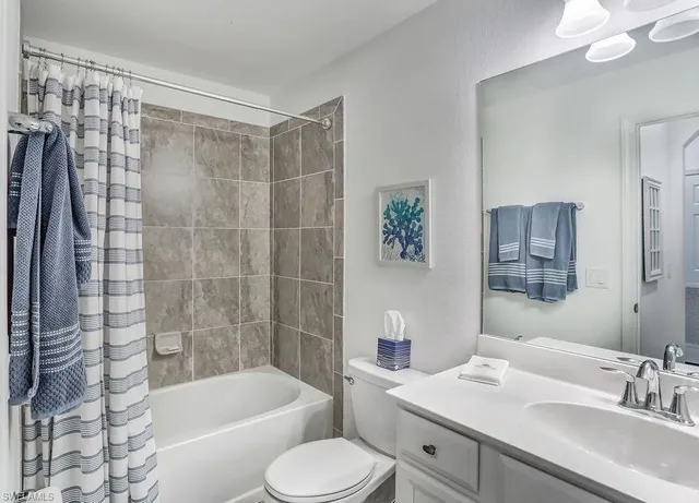 a bathroom with a granite countertop sink mirror and vanity