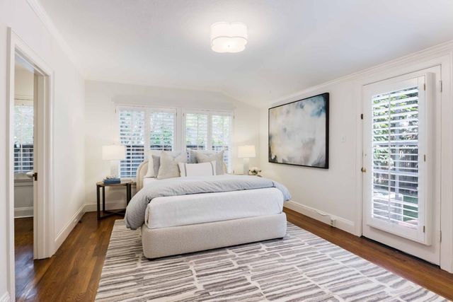 a bedroom with a large bed and a window