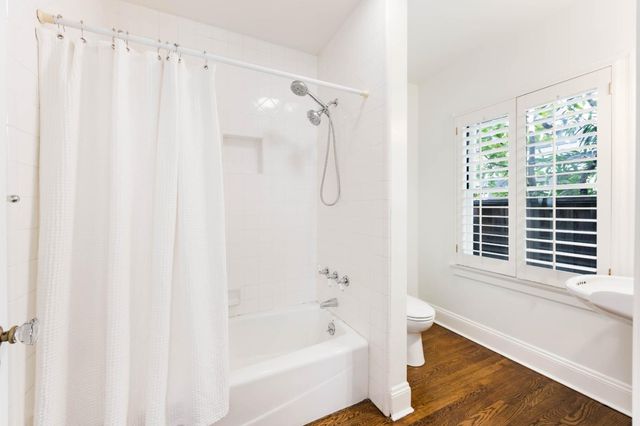 a bathroom with a shower curtain and a window
