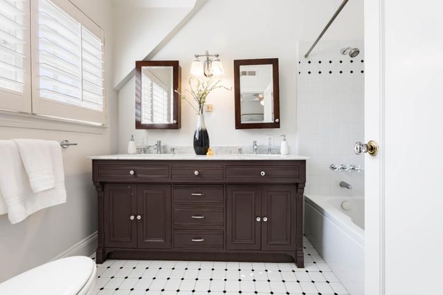 a bathroom with a sink vanity and a mirror