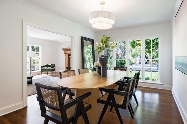 a view of a dining room with furniture window and wooden floor
