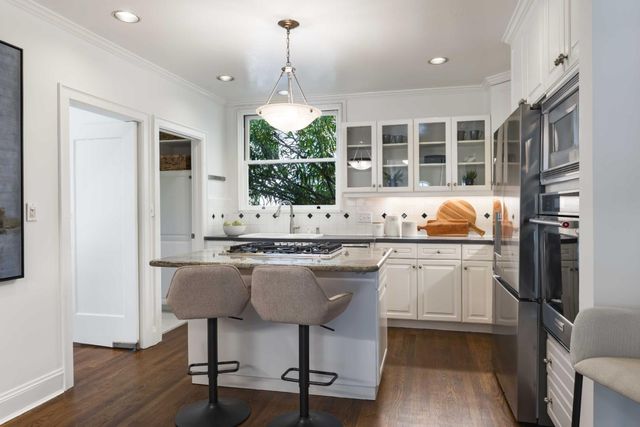 a kitchen with a sink cabinets and window