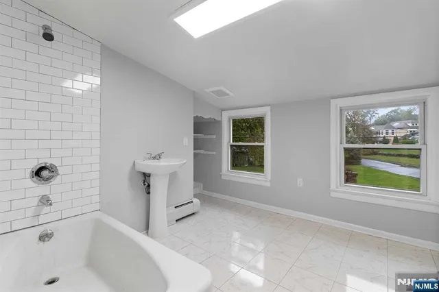 a bathroom with a bathtub and window
