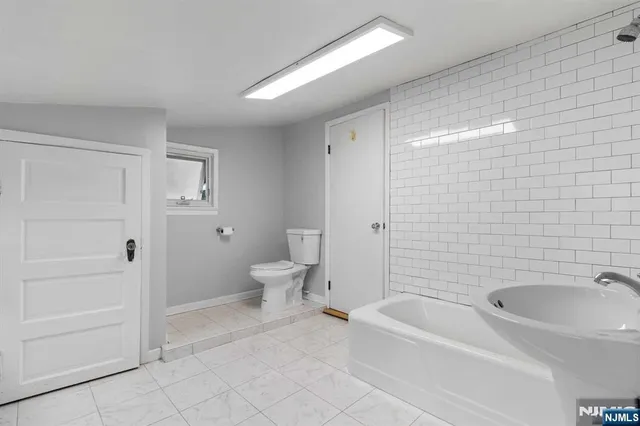 a bathroom with a bathtub and toilet