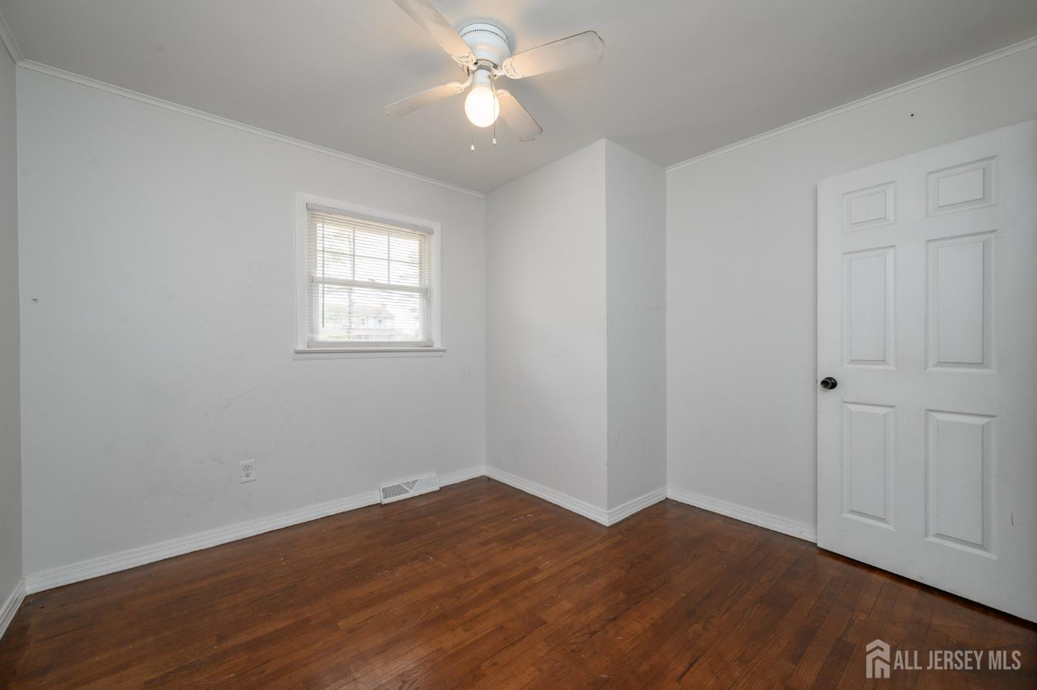 384 Cook Road Jackson, NJ 08527 - Photo 16 of 31 a view of empty room with wooden floor and fan
