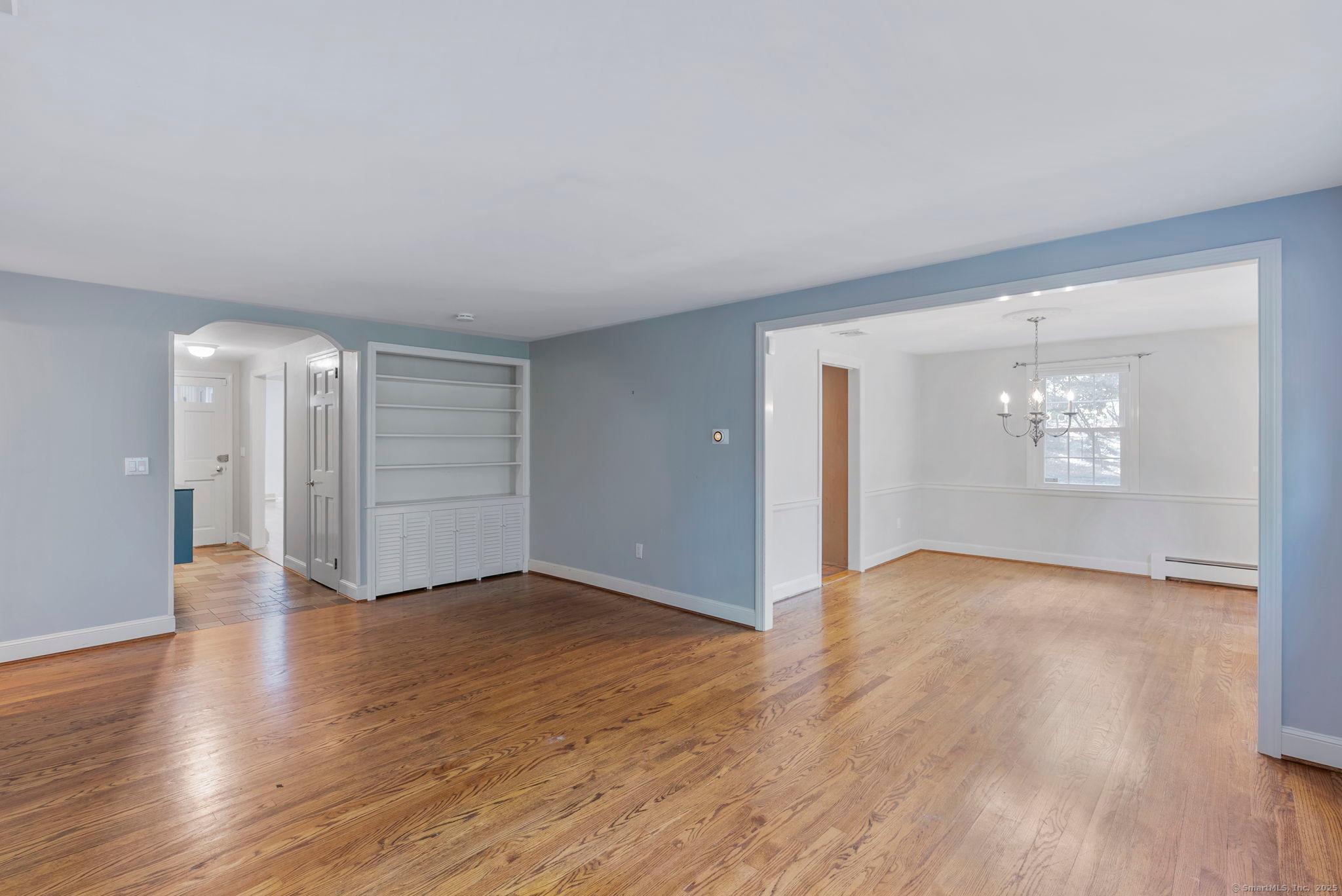 23 Wagon Road Glastonbury, CT 06033 - Photo 11 of 40 an empty room with wooden floor and windows