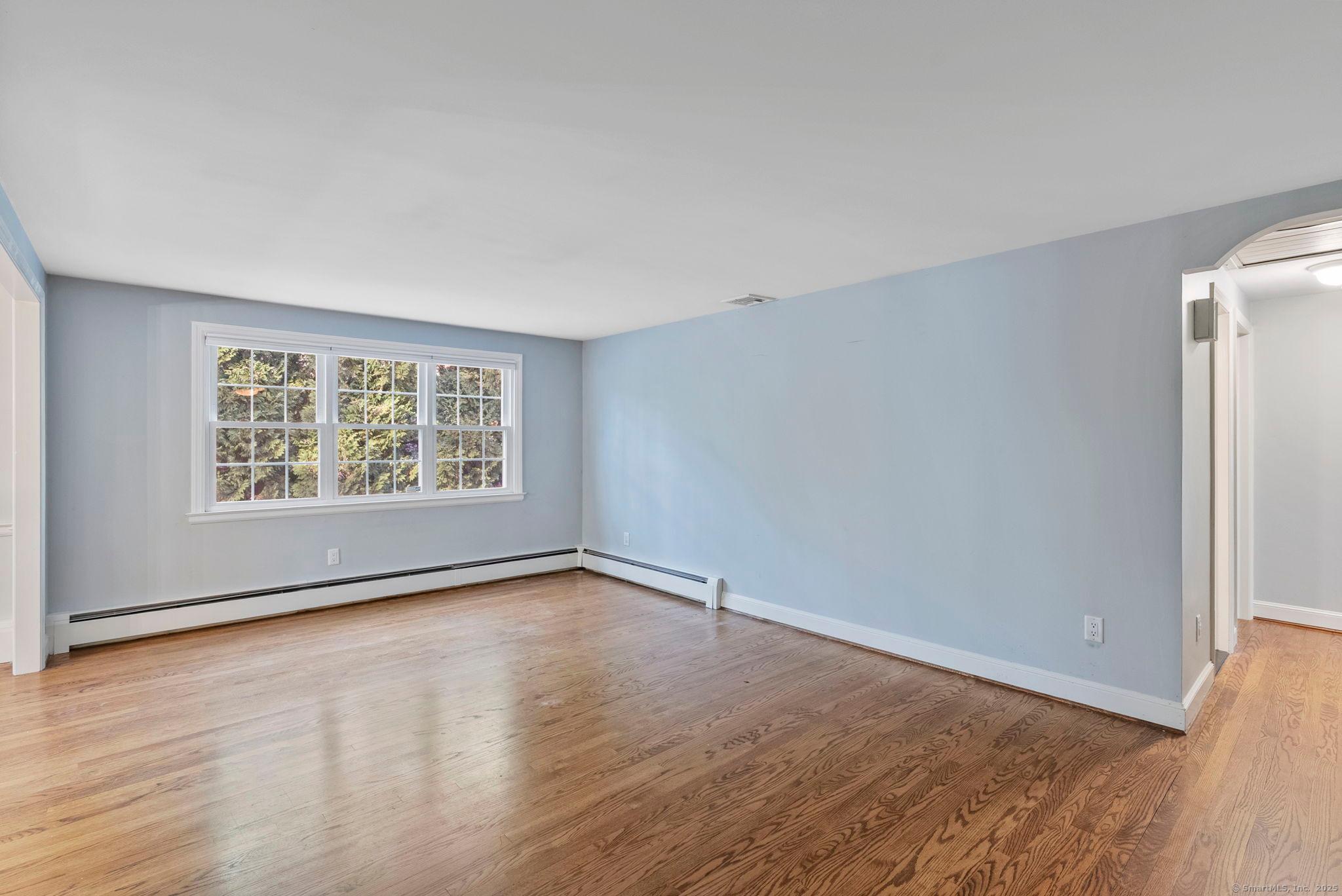 23 Wagon Road Glastonbury, CT 06033 - Photo 12 of 40 an empty room with wooden floor and window