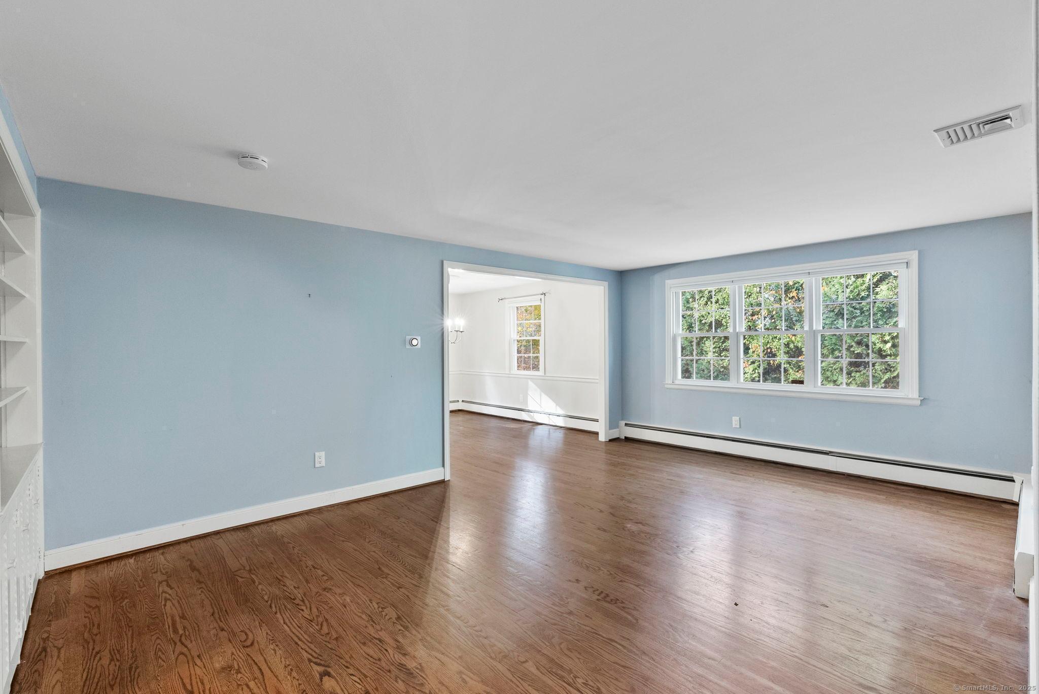 23 Wagon Road Glastonbury, CT 06033 - Photo 13 of 40 an empty room with wooden floor and windows