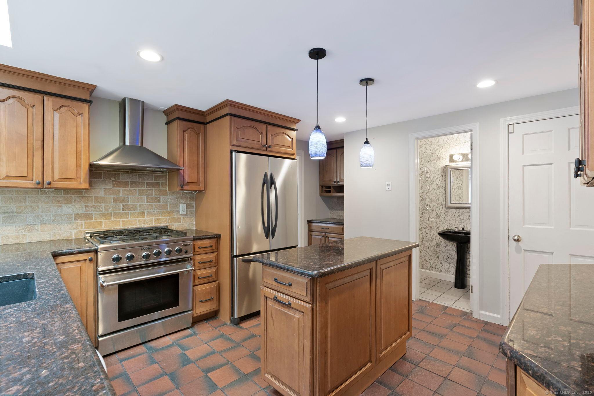 23 Wagon Road Glastonbury, CT 06033 - Photo 16 of 40 a kitchen with refrigerator and cabinets