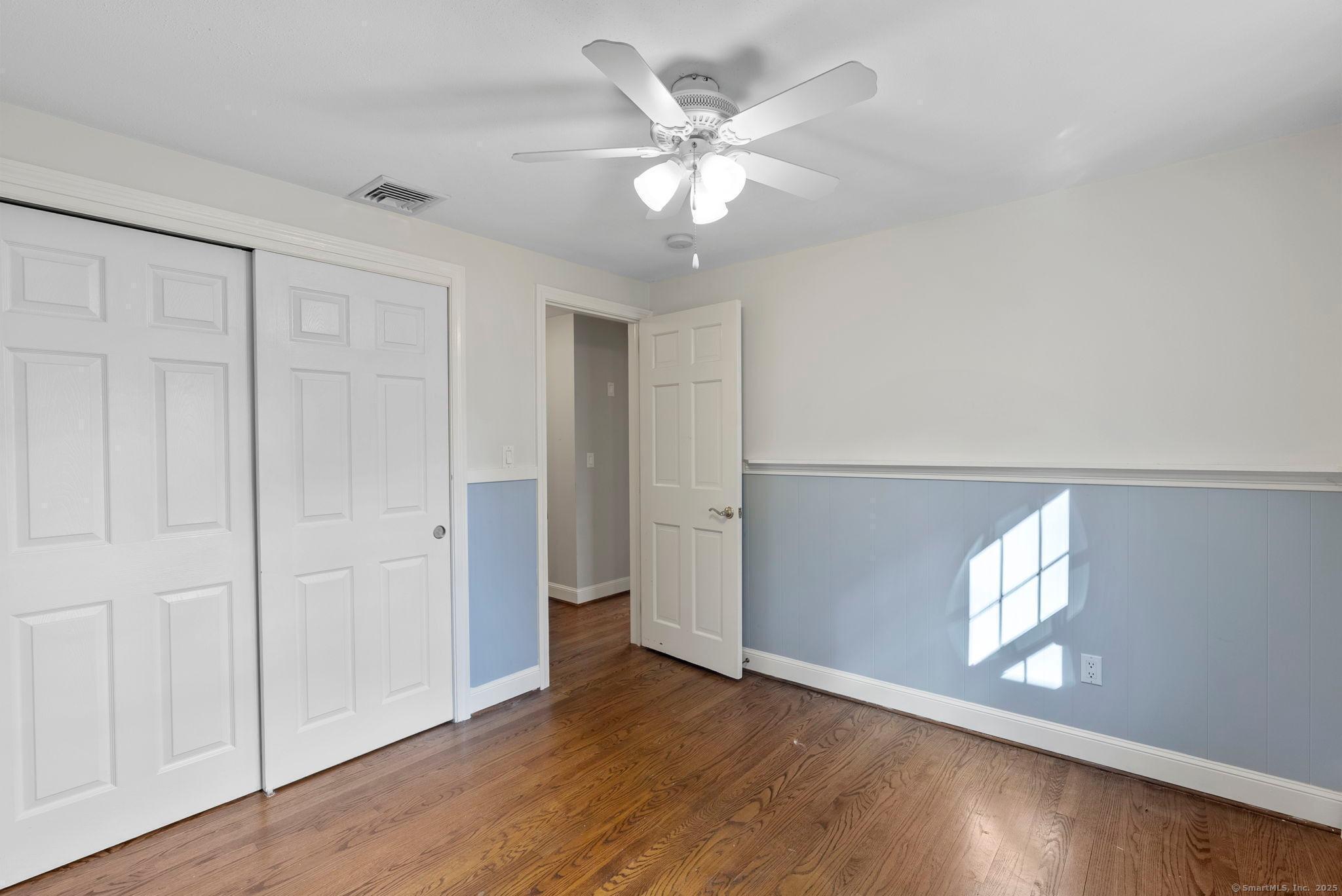 23 Wagon Road Glastonbury, CT 06033 - Photo 28 of 40 an empty room with wooden floor and windows