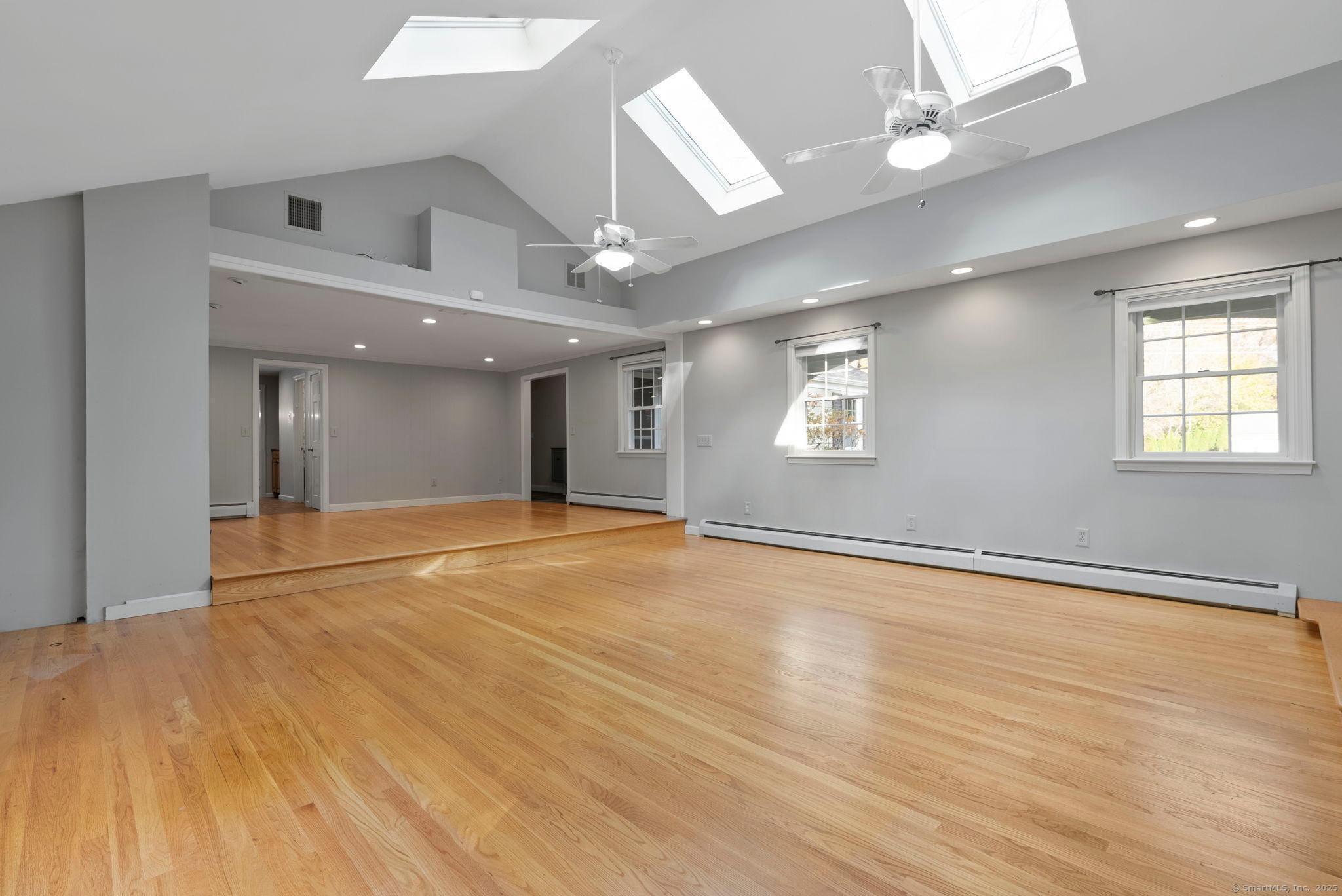 23 Wagon Road Glastonbury, CT 06033 - Photo 3 of 40 an empty room with wooden floor and windows