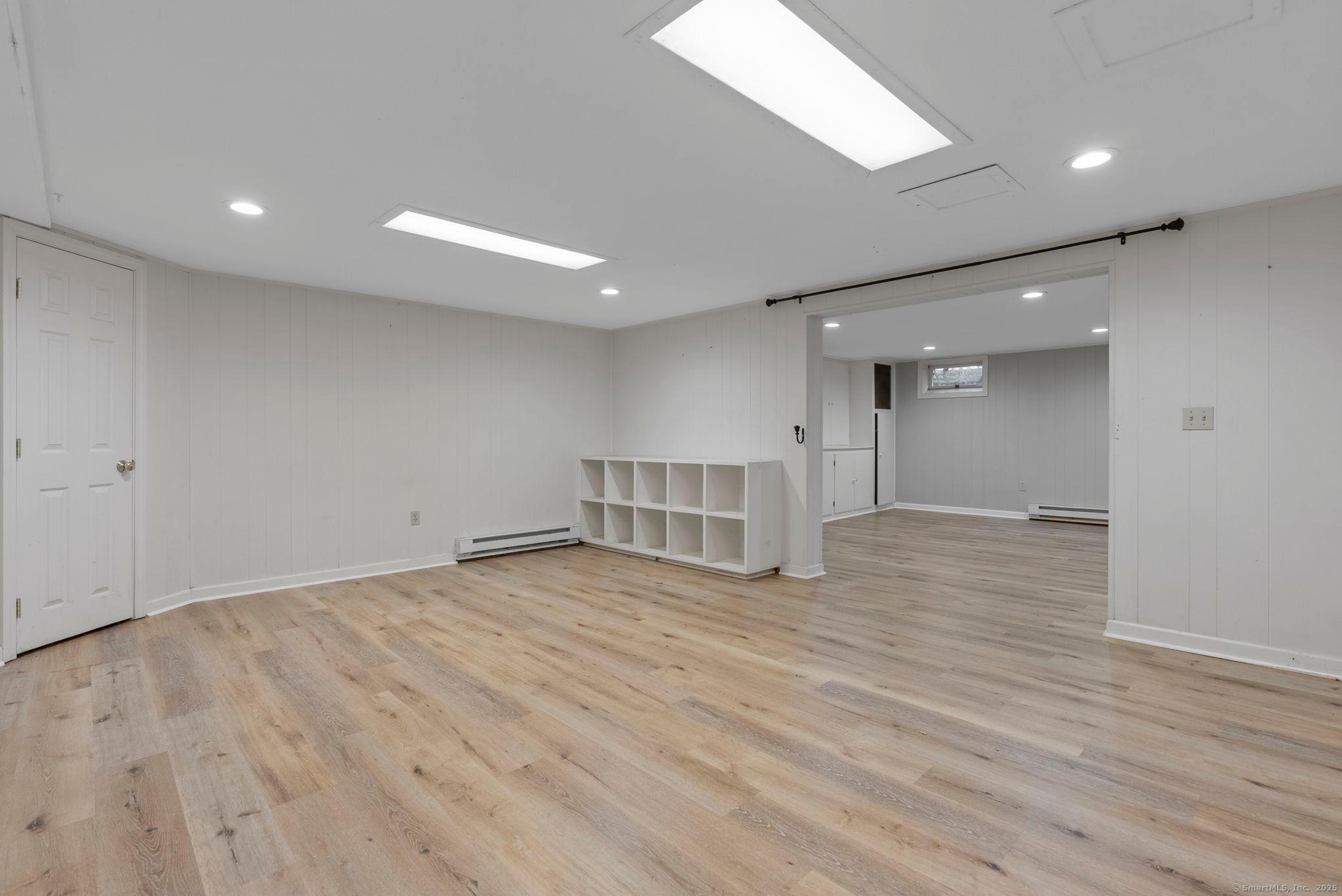 23 Wagon Road Glastonbury, CT 06033 - Photo 33 of 40 a view of an empty room with wooden floor