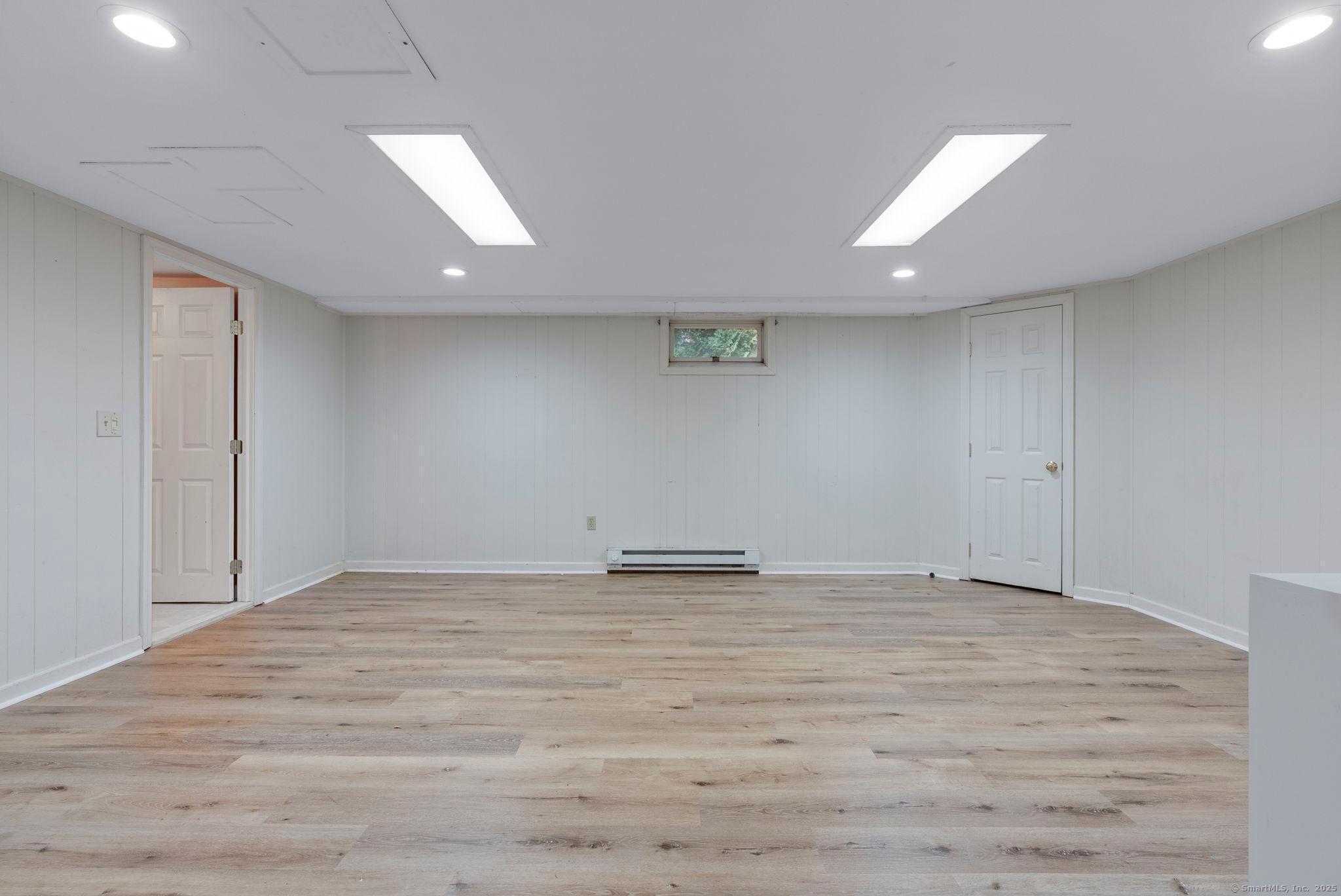 23 Wagon Road Glastonbury, CT 06033 - Photo 34 of 40 an empty room with wooden floor and natural light