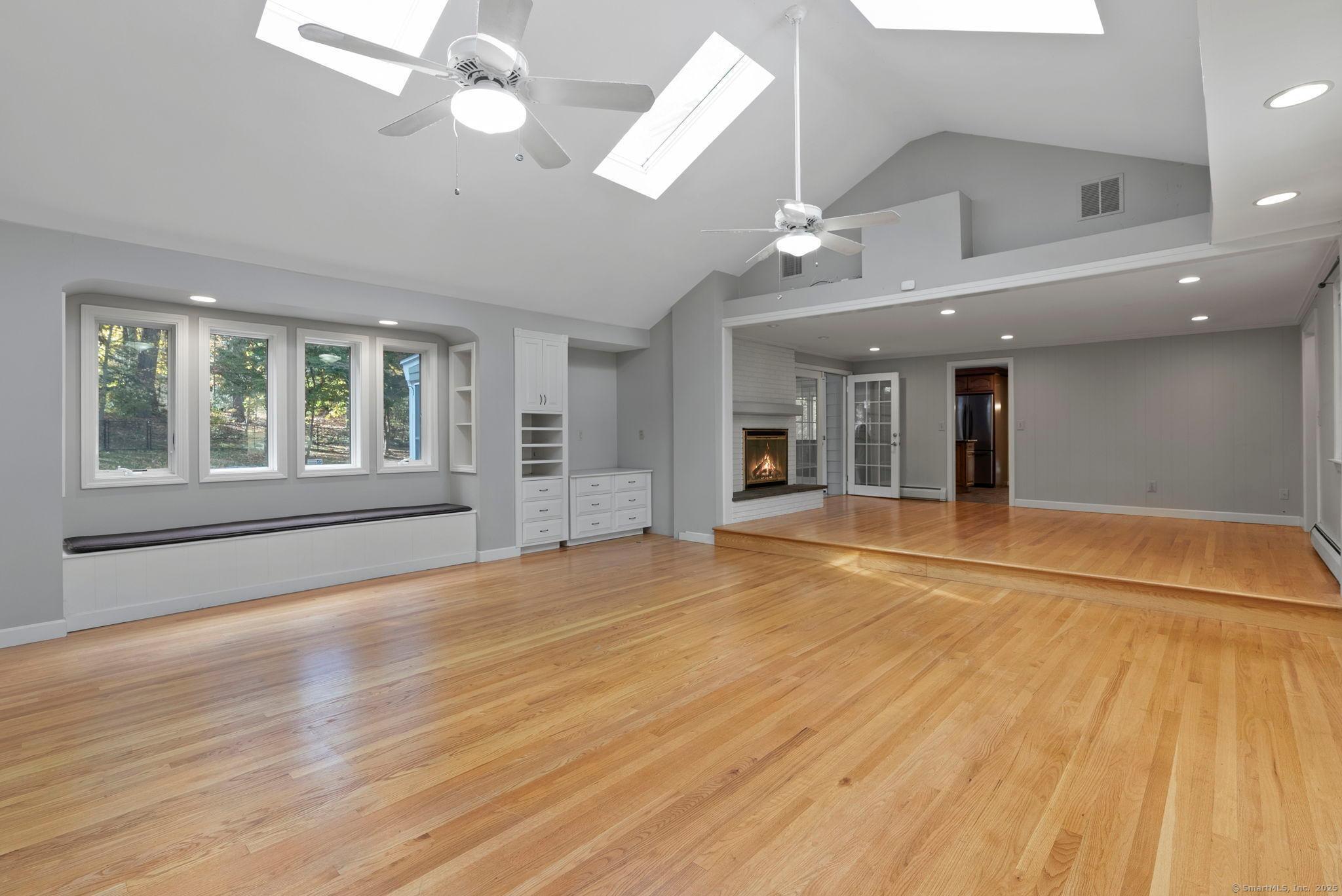 23 Wagon Road Glastonbury, CT 06033 - Photo 4 of 40 an empty room with wooden floor and windows