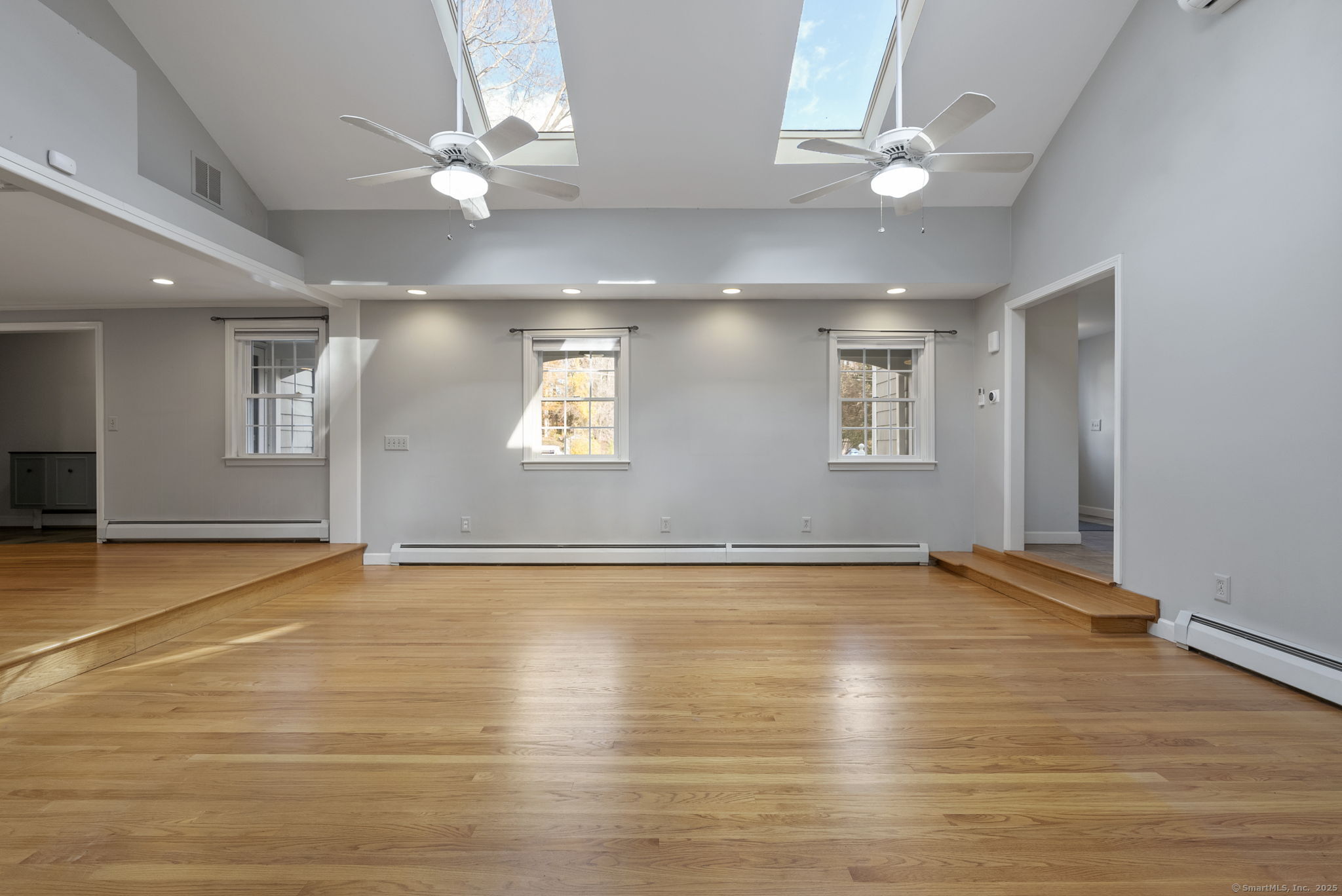 23 Wagon Road Glastonbury, CT 06033 - Photo 9 of 40 a view of an empty room with window and wooden floor