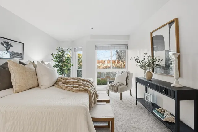 a bedroom with a large bed and a windows