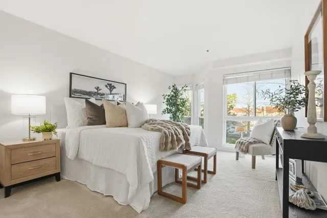 a bedroom with bed and a large window