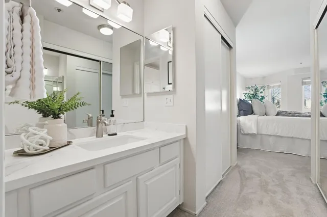 a bathroom with a sink a vanity and a mirror