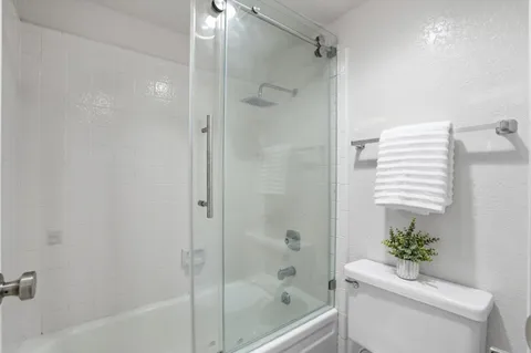 a bathroom with a shower and a toilet