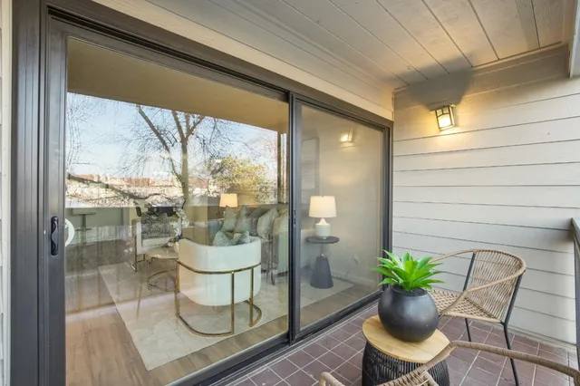 a room with a potted plant and a large window with garden view