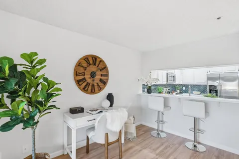 a view of a workspace with furniture and a potted plant