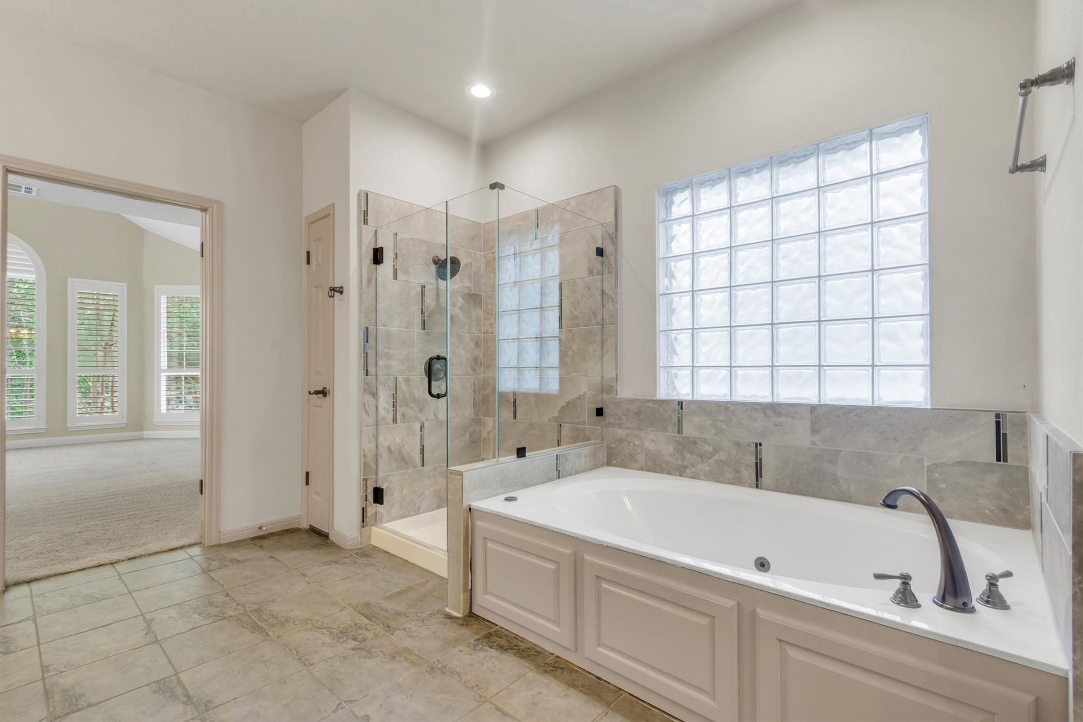 6008 Tributary Ridge Court Austin, TX 78759 - Photo 14 of 36 Relax with this primary bathroom's spacious soaking tub and walk-in shower.