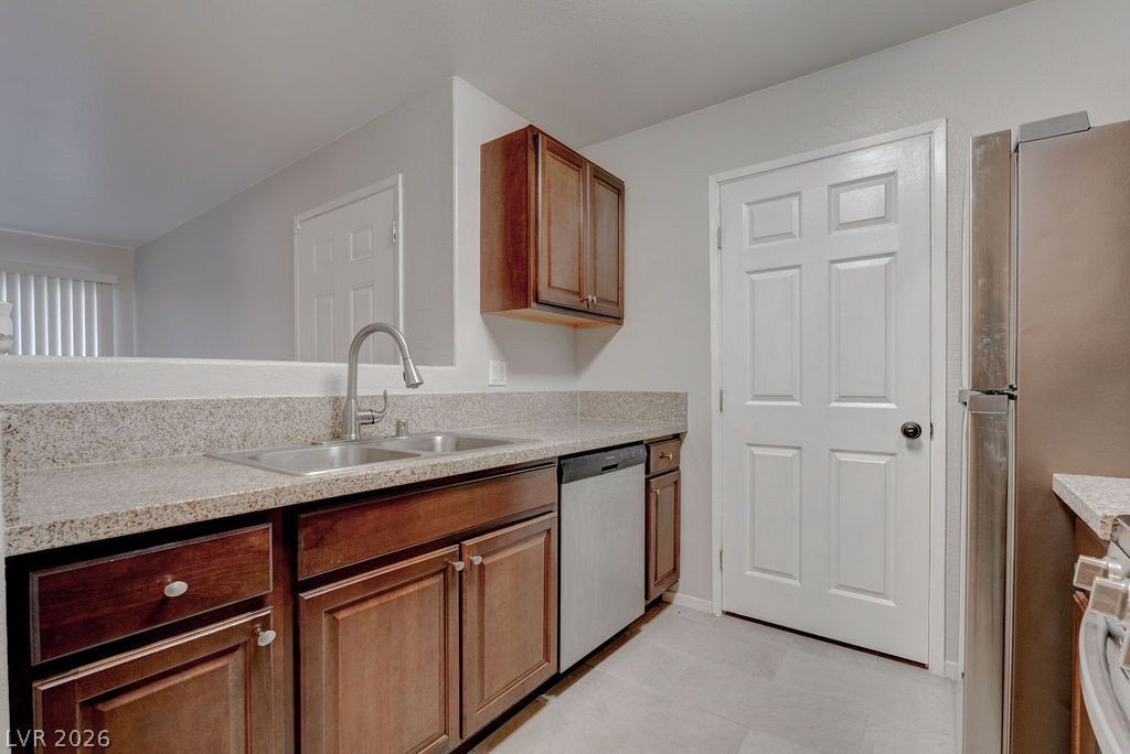 7885 West Flamingo Road, Unit 1016 Las Vegas, NV 89147 - Photo 10 of 24 A well-appointed kitchen features rich wood cabinetry and ample counter space.