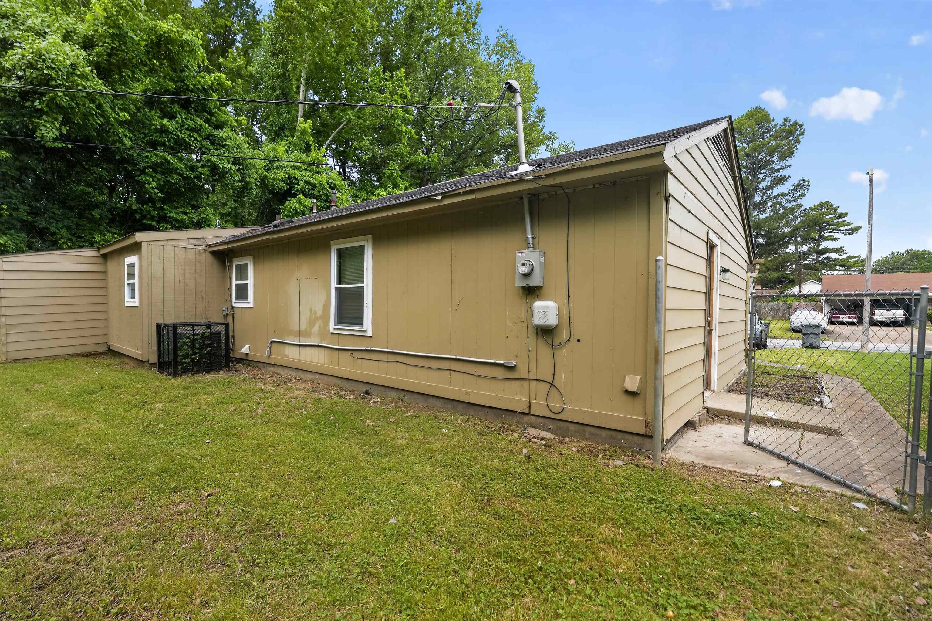 3608 Cane Ridge Drive Memphis, TN 38109 - Photo 9 of 31 Exterior siding structure with multiple windows and a utility meter