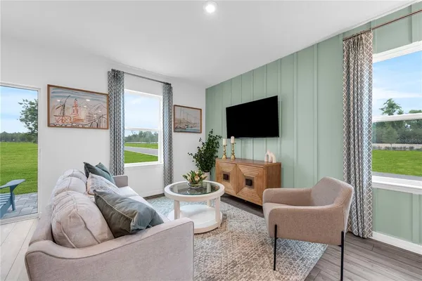 a living room with furniture and a flat screen tv