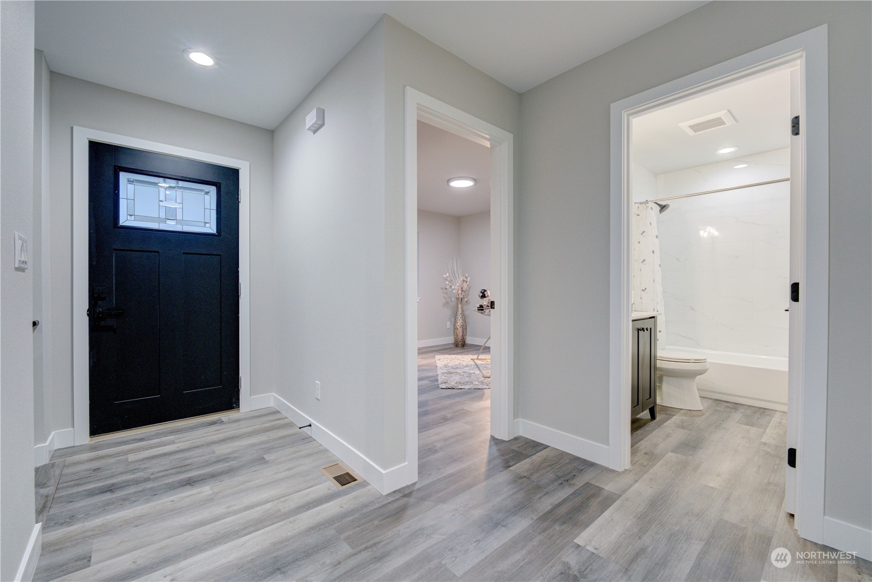 1861 Watkins Road Freeland, WA 98249 - Photo 4 of 39 a view of a hallway with wooden floor and a bathroom