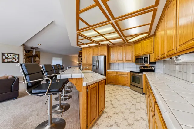 a kitchen that has a lot of cabinets and wooden floor